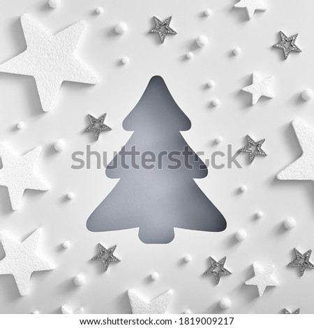 Christmas minimal concept - monochrome Christmas tree shape with white and silver star pattern. Square composition, flat lay, view from above. Layout mockup. Abstract template.