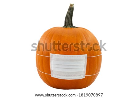 Halloween jack o'lantern jackolantern face pumplin wearing a covered pandemic covid-19 medical surgery mask uncarved