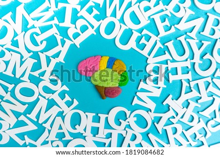 The human brain is surrounded by letters. Development of intelligence. Bleeding of the brain through reading. Get education. The concept of learning.