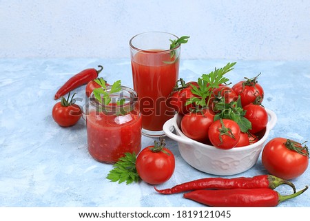 Tomato juice, sauce, pasta and ingredients on a specific table. Detox diet and weight loss concept, natural nutrition, healthy and wholesome food. Summer drinks, vitamins C,