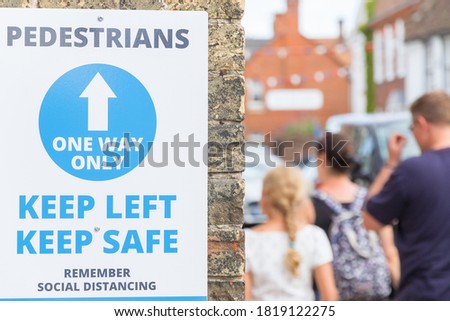 One way system and social distancing sign displayed on street of the seaside town Southwold, UK