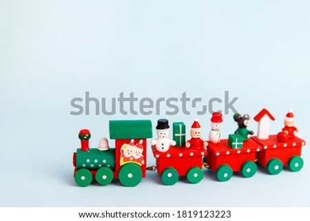 Little red christmas toy train on blue background