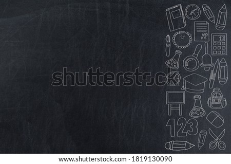 Doodle a set of back to school education symbols drawn in chalk on a blackboard
