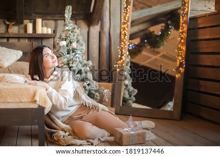 Woman at home for New Years or Christmas in the bedroom. Selective focus.