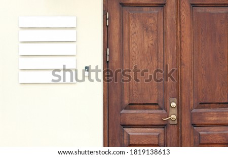 Classic wooden office doors with blank signboards on the wall to place company names and logos, business mockup