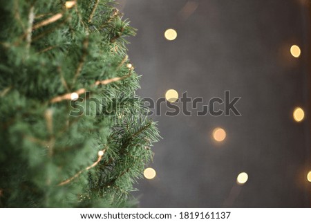 christmas tree on gray background with bokeh of bright lights