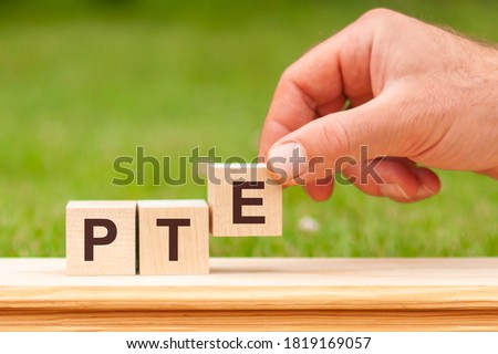 PTE word concept on cubes, english concept. Pearson Tests of English PTE concept Foreign Language exams.