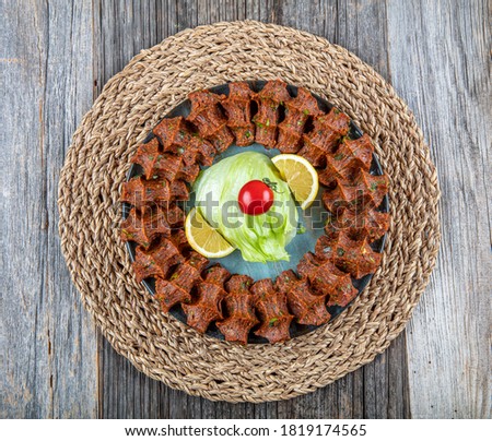 Traditional Turkish appetizer Cigkofte with lavash, ingredients are raw, meat bulgur ,onion, tomato paste, chili pepper and salt. Turkish local raw food concept.