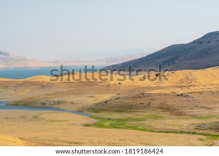 The San Luis Reservoir during dry and hot season, artificial lake on San Luis Creek in the eastern slopes of the Diablo Range of Merced County, California. USA Royalty-Free Stock Photo #1819186424