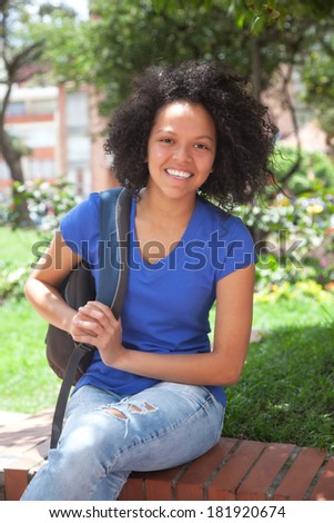Caribbean student sitting in a park