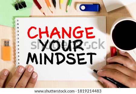 White blank notepad on office wooden table Change your mindset concept.