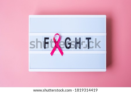 October Breast Cancer Awareness month, Pink Ribbon on lightbox with FIGHT text background for supporting people living and illness. International Women, Mother and World cancer day concept