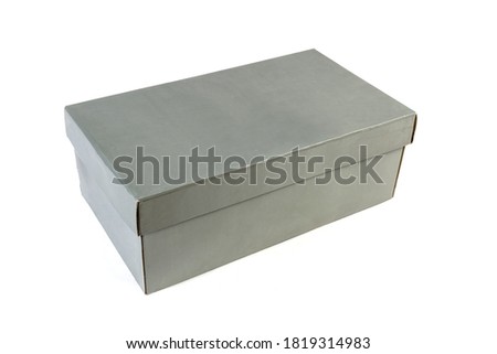 Gray cardboard shoes box with closed lid on a white background 
