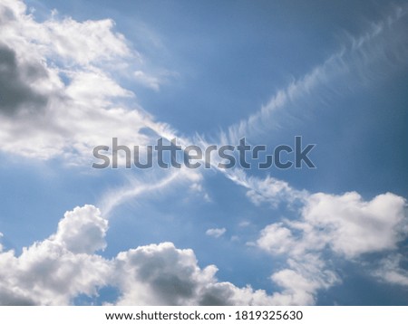 unusual beautiful summer sky with cross-like clouds