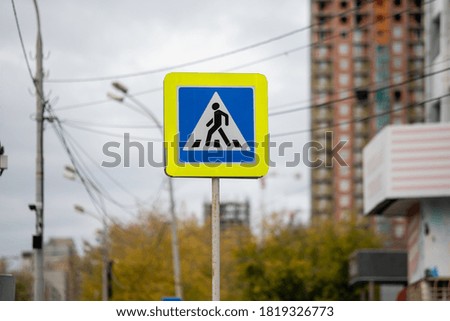 Pedestrian crossing sign board. Crosswalk pictogram sign on the traffic signboard.