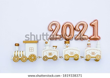 Happy New year 2021. Christmas locomotive with numbers 2021 on a bright white background. Copyspace. Flatlay.