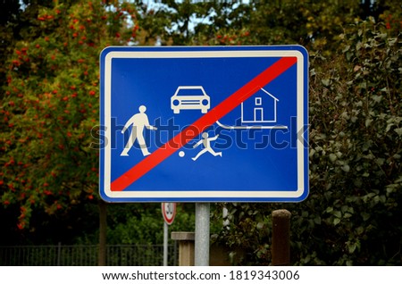 vertical metal repair signs commanded direction of travel, one way, no entry, pedestrian zone, respirator mask dead end street in detail in the background trees