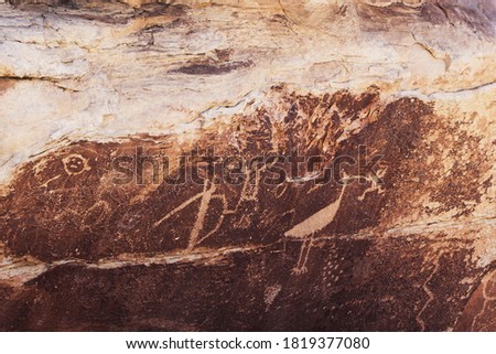 A petroglyph of a bird holding an object in its beak seen at Petrified National Forest, Arizona, USA
