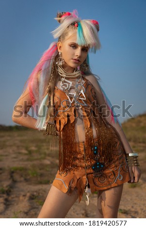 teen girl in stylish fantasy clothes in vintage middle eastern style ornate with gold jewelry in the setting sun