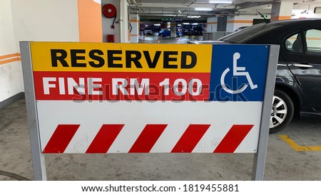 signage indicates only disabled people can use this parking area.