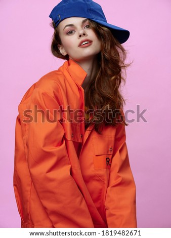 Fashionable woman with cap on her head lifestyle clothing pink background