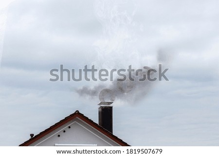 Residential house with chimney and CO2 emissions