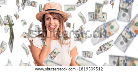 Young beautiful woman wearing summer hat and t-shirt looking confident at the camera smiling with crossed arms and hand raised on chin. thinking positive.