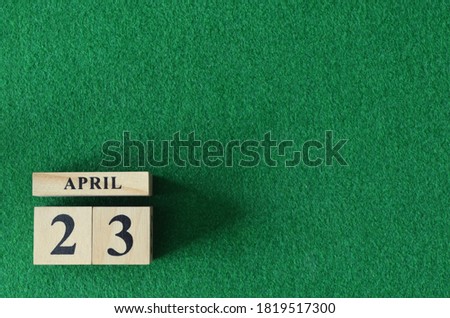 April 23, number cube on  snooker table, sport background.