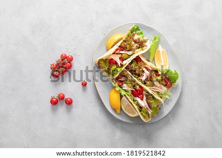 Tacos with chicken meat, salad and vegetables