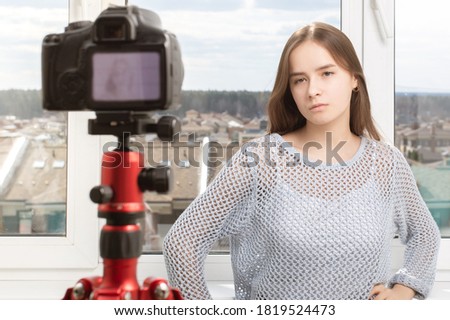 Photoshoot at home. Girl posing in front of the camera, takes pictures