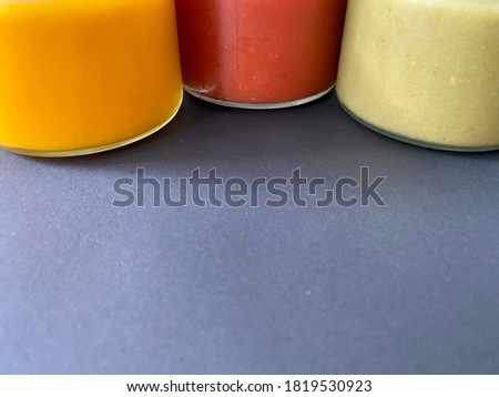 Three different colors of healthy soups with black background
