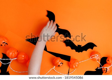 Little boy playing with spooky halloween decorations.