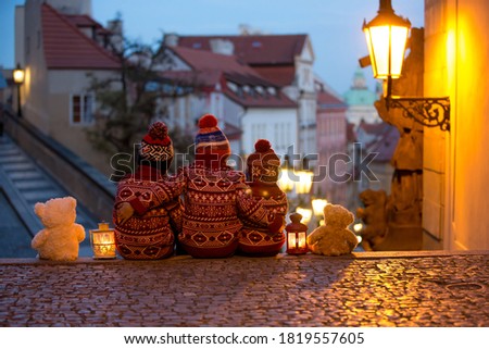 Beautiful children, three boy brothers, casually dressed, looking at night view of Prague city, wintertime