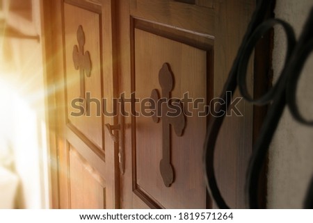 Creative abstract concept of faith and peace. Church door with religious cross. Spiritual authentic idea of entering Christianity.