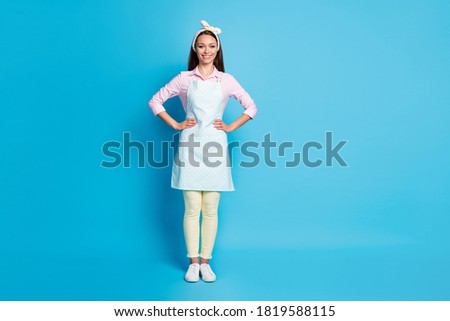 Full size photo of nice lovely friendly woman put hands waist enjoy routine working cleaning day wear good look outfit isolated over blue color background