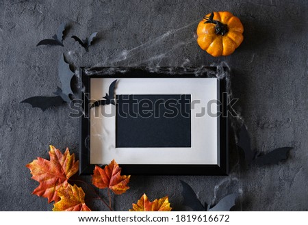 Modern Halloween background with pumpkins, bats and black frame on dark background. Halloween party invitation card mockup. 