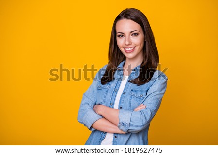 Photo of attractive confident business lady arms hands crossed good mood professional freelancer beaming smile wear casual denim shirt isolated vivid yellow color background