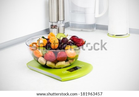 Fruit on the kitchen scale in a modern kitchen.