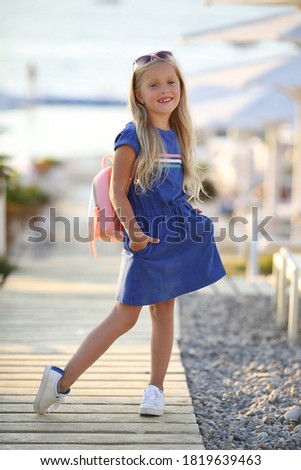 pretty preteen blonde girl outdoors in summer