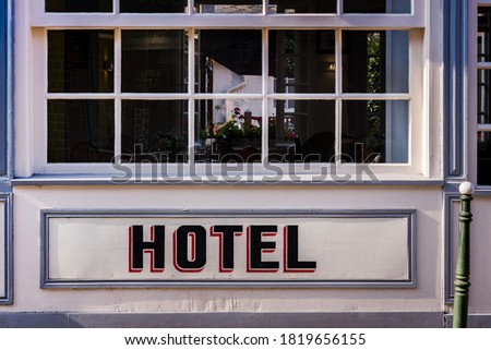 Hotel facade in France. Hotel text uppercase. Word hotel