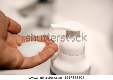 washing hands with foam liquid soap