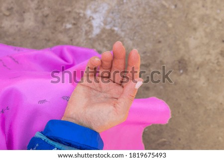 Relaxed female hand, palm up. National clothing. Women's ritual.