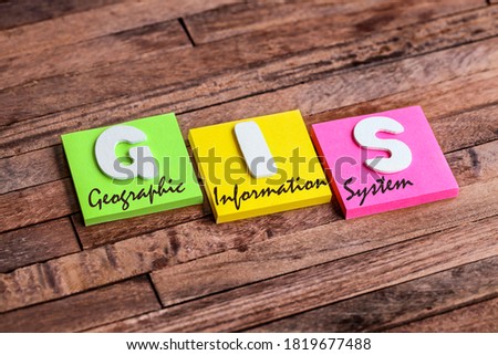 Colorful square papers with wooden white letters for the acronym word GIS means Geographic Information System Royalty-Free Stock Photo #1819677488