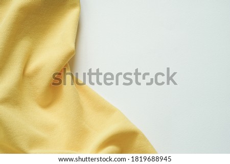 yellow crumpled fabric placed on white background. Royalty-Free Stock Photo #1819688945