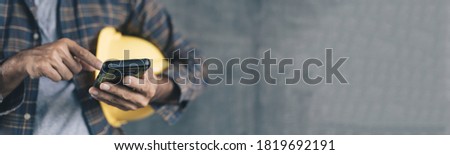 Foerman use Smart phone on Cement wall with copy space for Banner Royalty-Free Stock Photo #1819692191