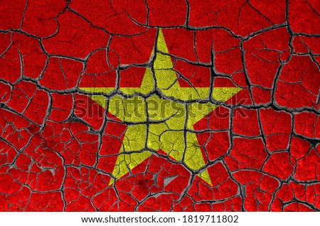 Flag of Vietnam on a cracked wall, dry ground	