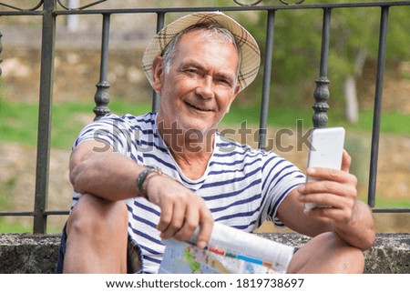tourist with world map and mobile or cell phone