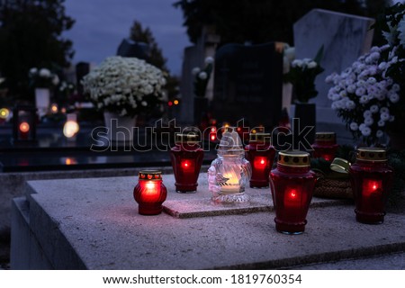 rememberance candle lanterns in the cemetery on all saints day . Royalty-Free Stock Photo #1819760354