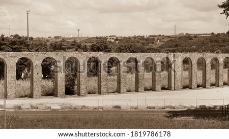 Obidos Aqueduct or Aqueduto de Óbidos, ancient stone masonry building, over 3 km-long. Built by Catherine of Austria around 1570, classified as Property of Public Interest 1962. Sepia tone photography
