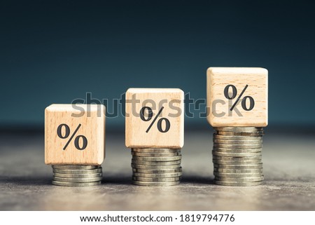Wood blocks with percentage symbol on heap coins stair, increase percentage on increase money Royalty-Free Stock Photo #1819794776